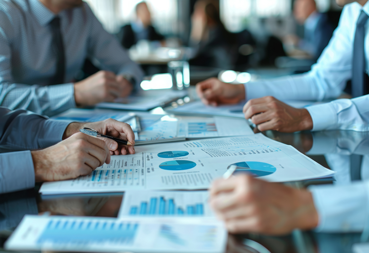 Executives engage in a detailed business meeting, analyzing a fi